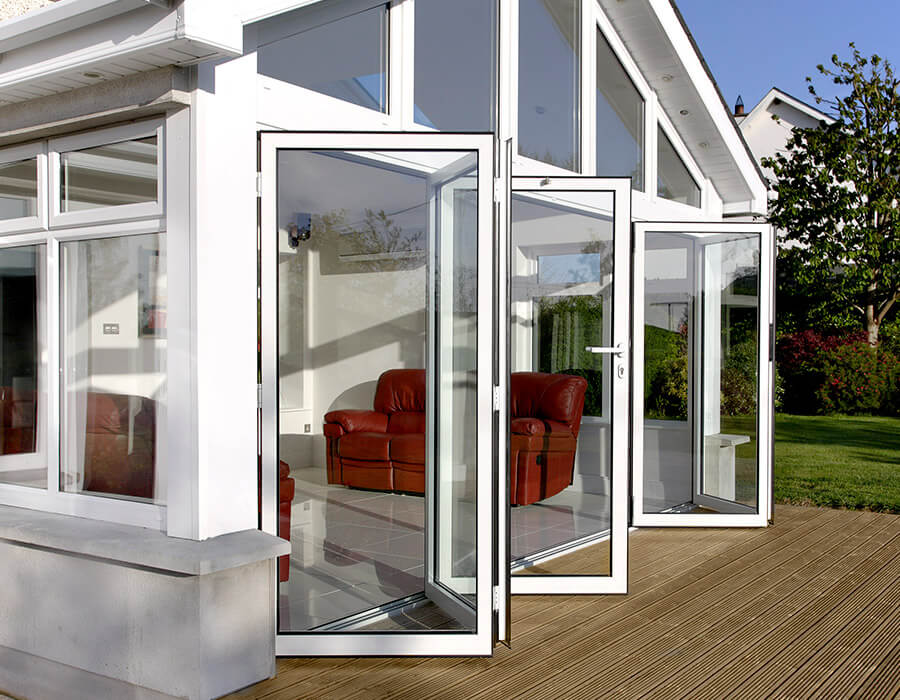 Conservatory with open white uPVC bifold doors