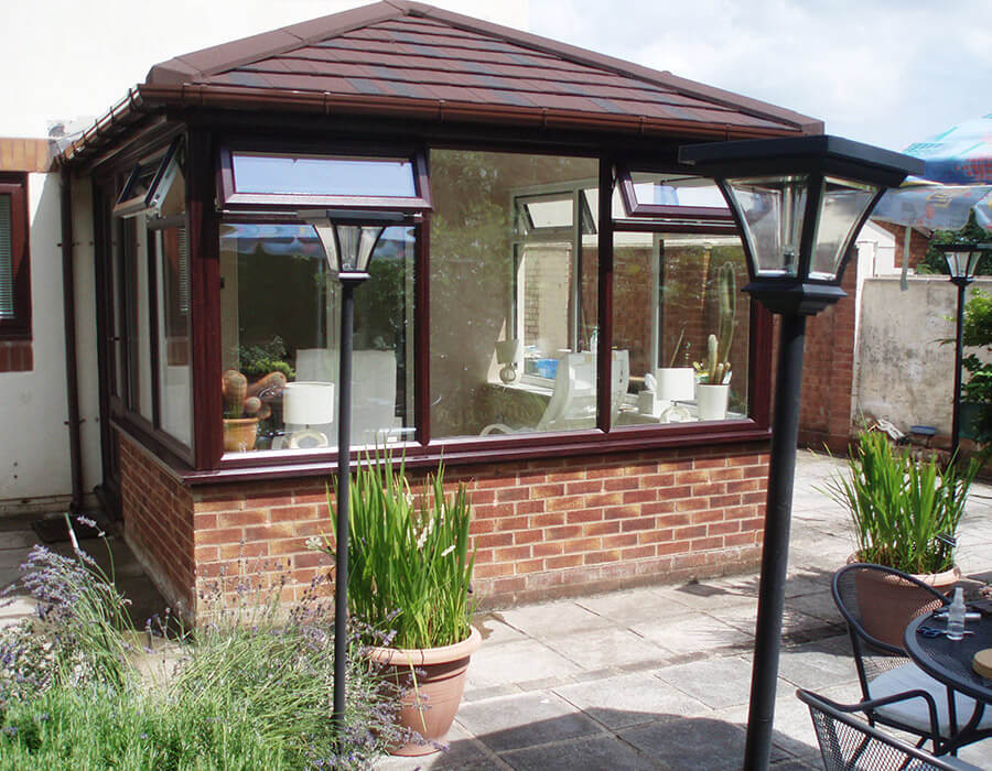 Front view of a rosewood effect uPVC conservatory