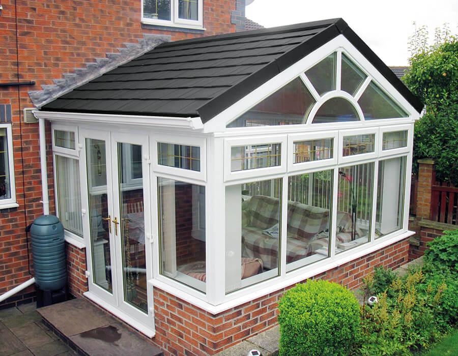 White uPVC gable conservatory with a grey tiled roof