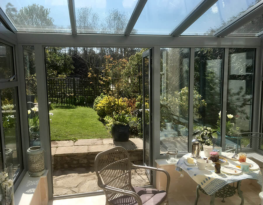 Grey uPVC lean to conservatory with a glass roof