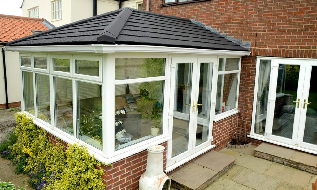 White uPVC conservatory with a grey tiled roof
