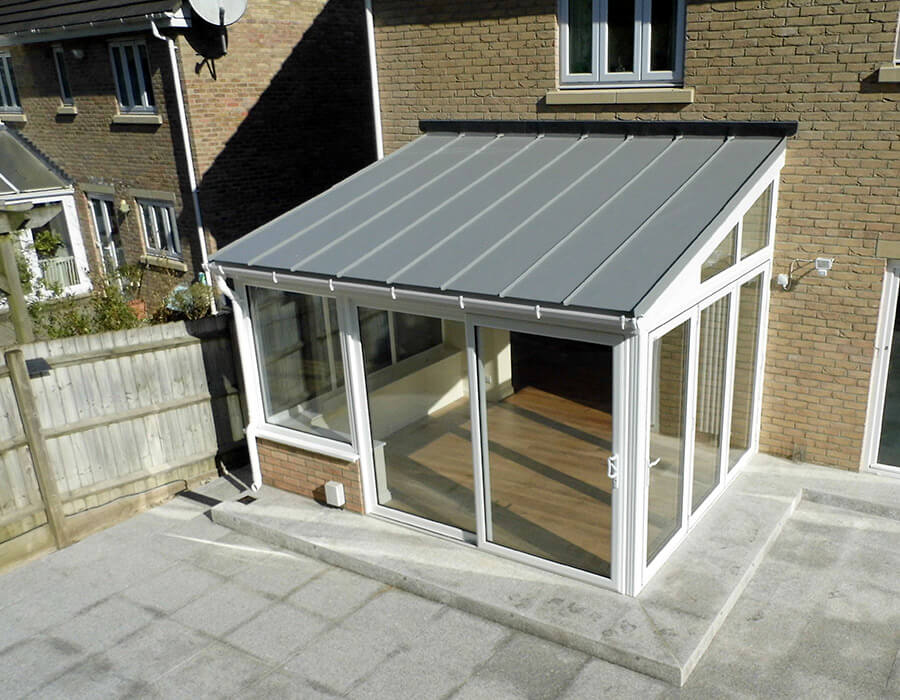 White uPVC lean to conservatory with a solid roof