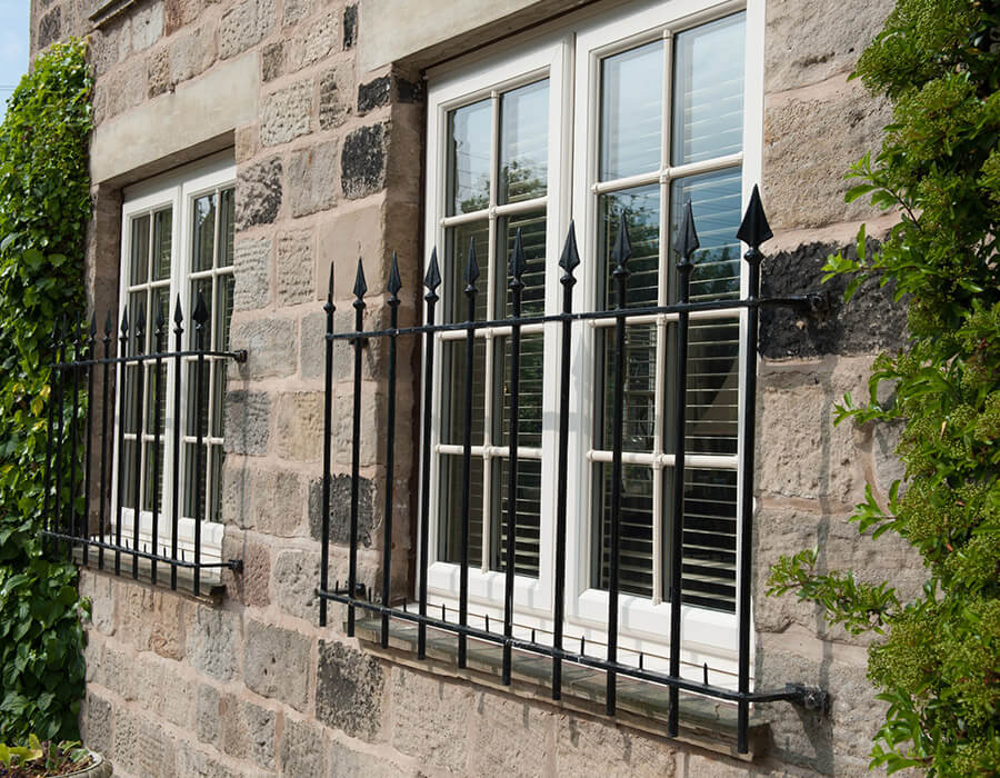 White uPVC casement windows with bars