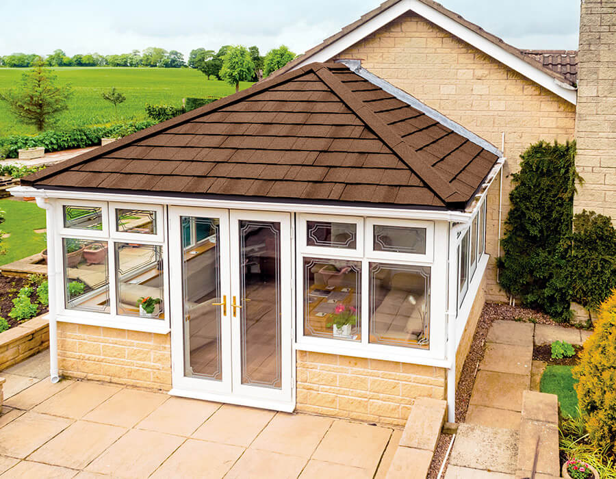 White uPVC conservatory with a brown tiled roof
