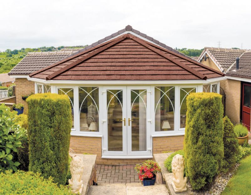 White uPVC victorian conservatory with a brown tiled replacement conservatory roofs