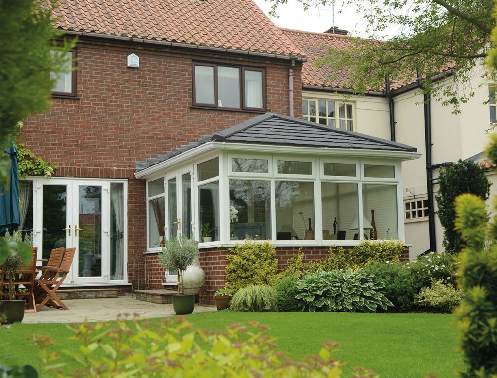 White uPVC conservatory with a grey tiled roof