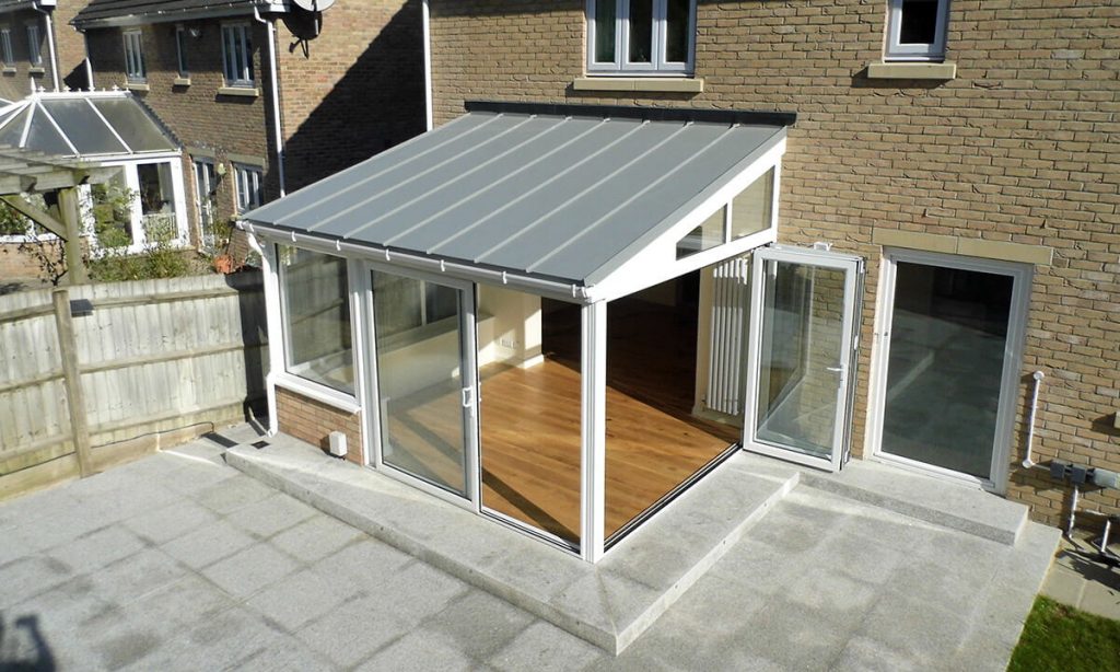 White uPVC lean to conservatory with a solid roof