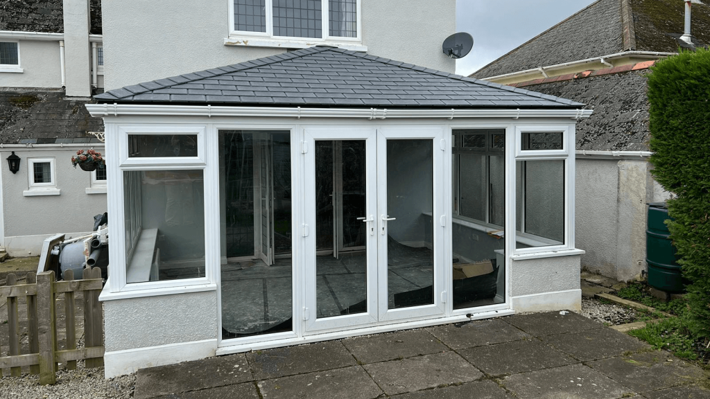 White upvc conservatory with a grey tiled roof