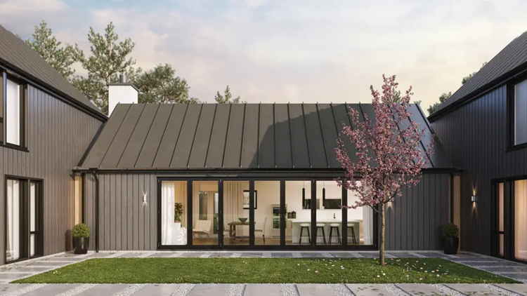 A modern barn-style home featuring Alumina aluminium bifold doors, seamlessly connecting the indoor space to the outdoor garden.
